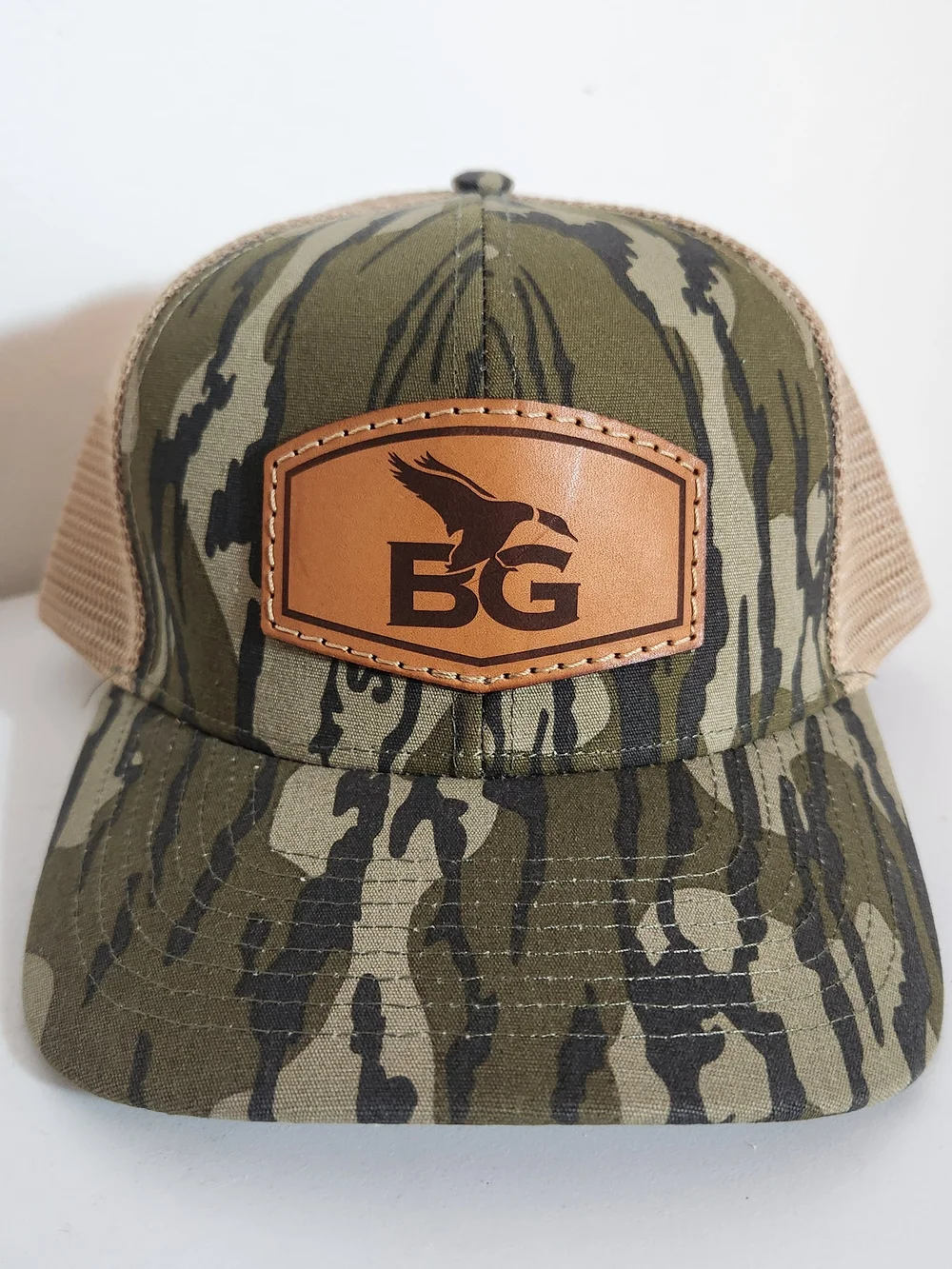 Lost Hat Co Buck Gardner Bottomland Camo Leather Patch Trucker Hat
